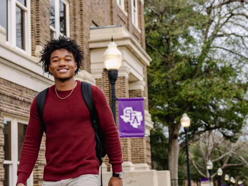 male student walking on campus