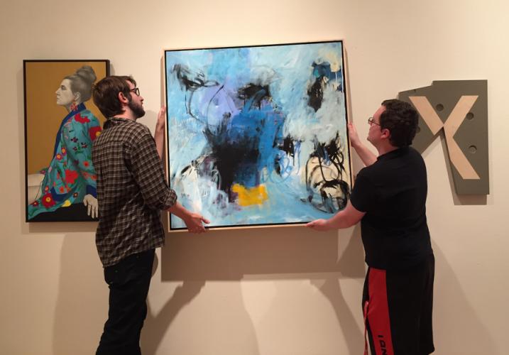 Art students Jacob Moffett and Weelynd McMullen install art work for this year’s Texas National Juried Art Competition and Exhibition.