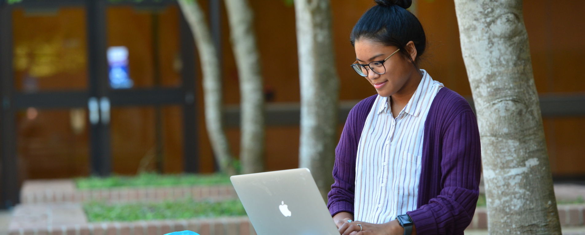 a student engages in studies using a laptop