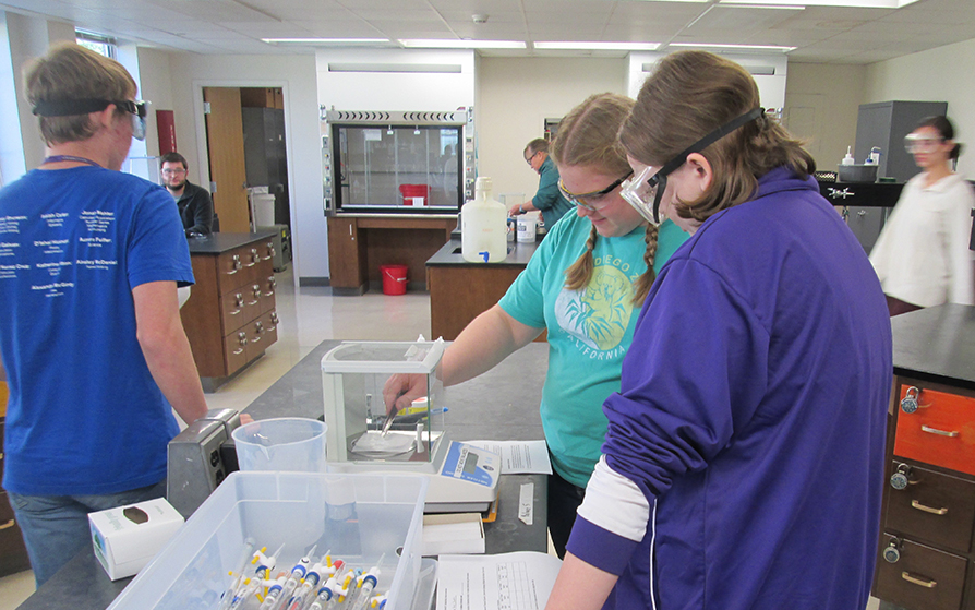 Undergraduate chemistry students working in a lab