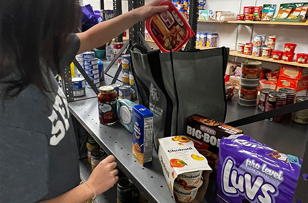Person stocking items from the pantry