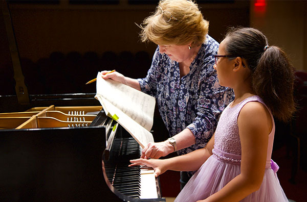 Student receiving piano instruction