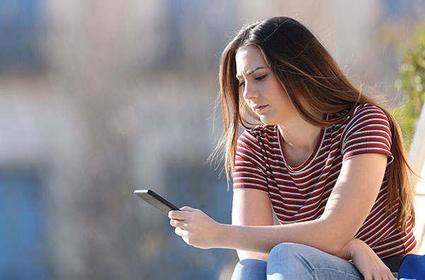 Stock image of woman looking at her phone