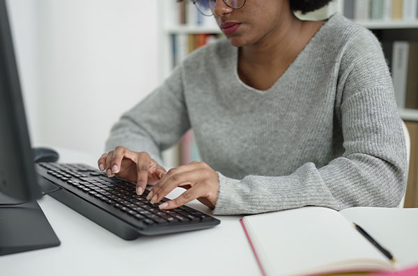 Stock image of woman typing on computer