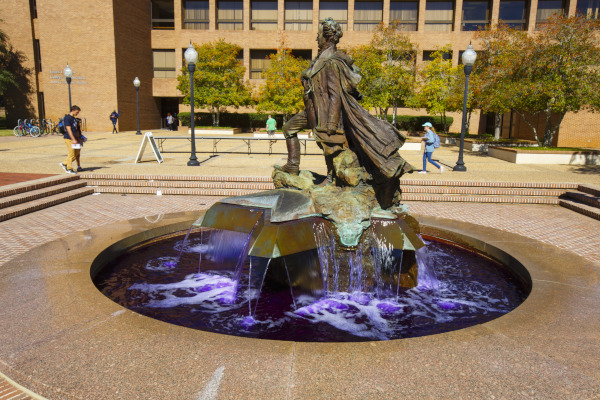 SFA's Surfin Steve fountain statue is shown with purple water below