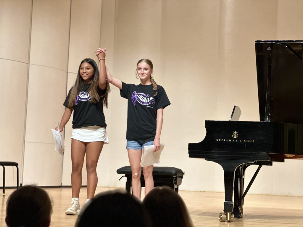 Two students take a bow following a performance