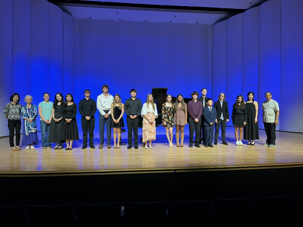 Students and faculty take a photo together in Cole Concert Hall