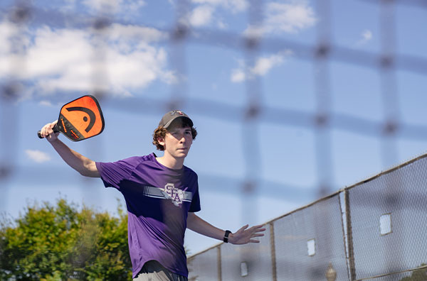 Student playing pickleball