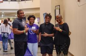 Student posing with their family