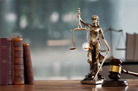 law desk with lady justice and a gavel