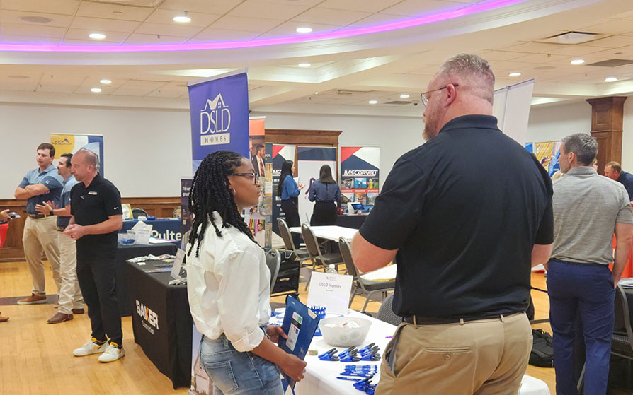 Students talking with prospective employers at the Construction Management Career Fair