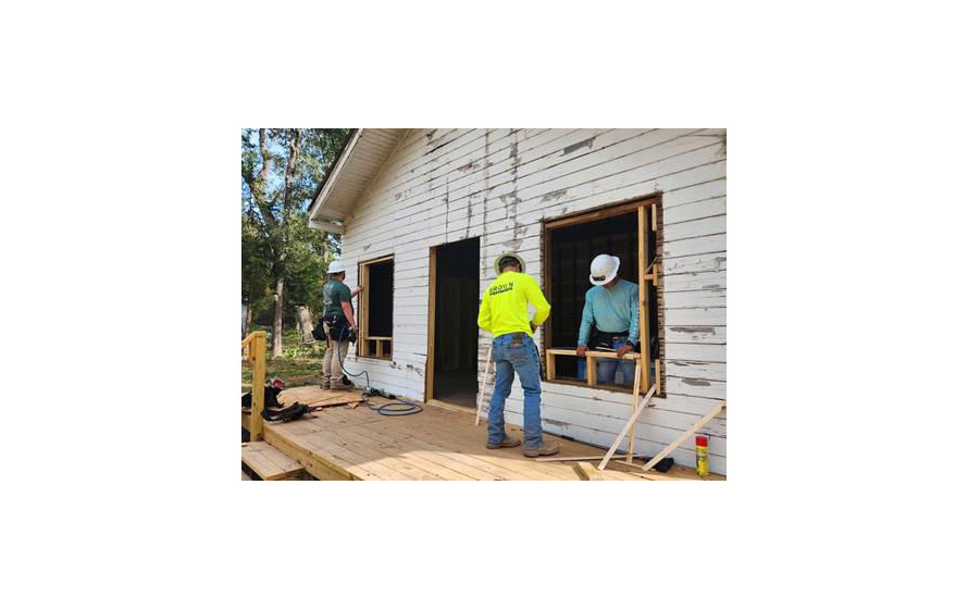 Construction Management students working on an old house
