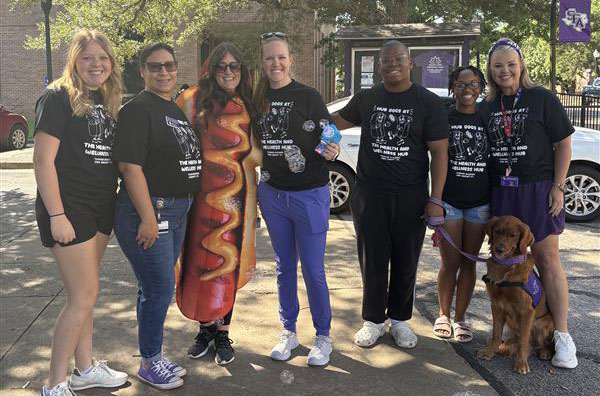 Students and employees smiling with Rudy