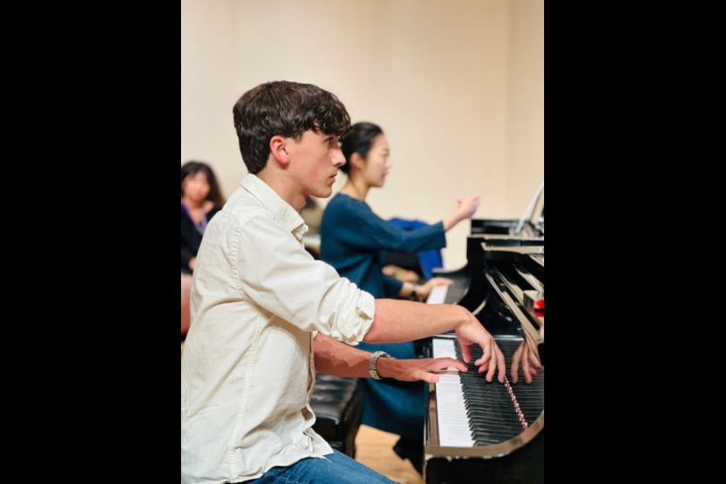 A student and faculty member rehearse together