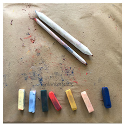 Seven pieces of colored charcoal and smudger sticks