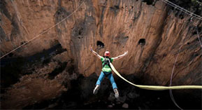 a person bungie jumping into a canyon