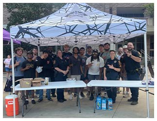 Police under a tent at National Night Out 2024