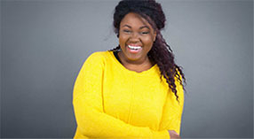 young woman smiling with arms crossed