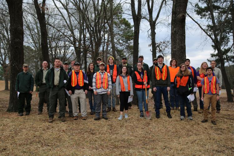 SFA participants, wearing orange vests, as well as staff members of the Texas A&M Forest Service