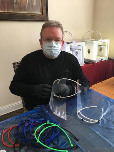 SFA faculty member Dan Bruton assembles face shields