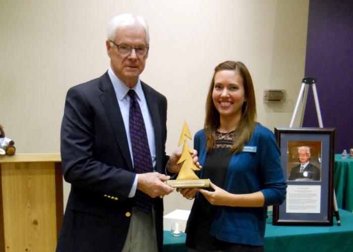 Dr. R. Scott Beasley eceives a token of recognition from Kendall Gay, director of the Texas Forestry Museum.