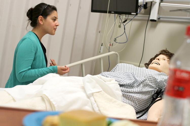 Alexis Malquist with her “patient,” a mannequin named Miss Hernandez