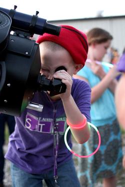 Elijah Duckworth views the moon through a high-powered telescope at the Stephen F. Austin State University Observatory during a constellation party.