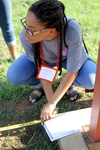 SFA  interior design student Rebecca Washington measures the distance from a historical monument to the road