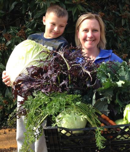 mother and son holding vegetables
