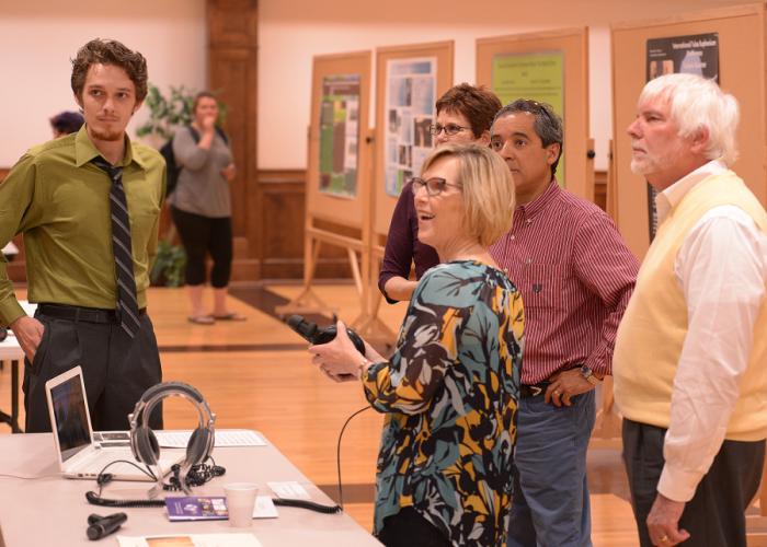 Attendees of SFA's 2016 Undergraduate Research Conference interact with and discuss "Recording a Polychoral Motet in a Cathedral Setting," a presentation by College of Fine Arts finalist Alexander Ballard.