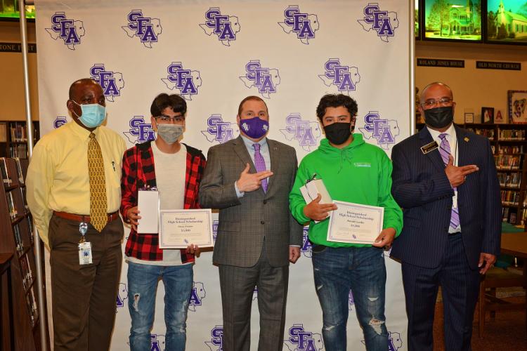 Interim NHS principal Dr. Kenneth Matthews, NHS senior Oscar Tinoco, SFA President Dr. Scott Gordon, NHS senior Ronald Castillo, and NHS deputy superintendent Michael Martin.
