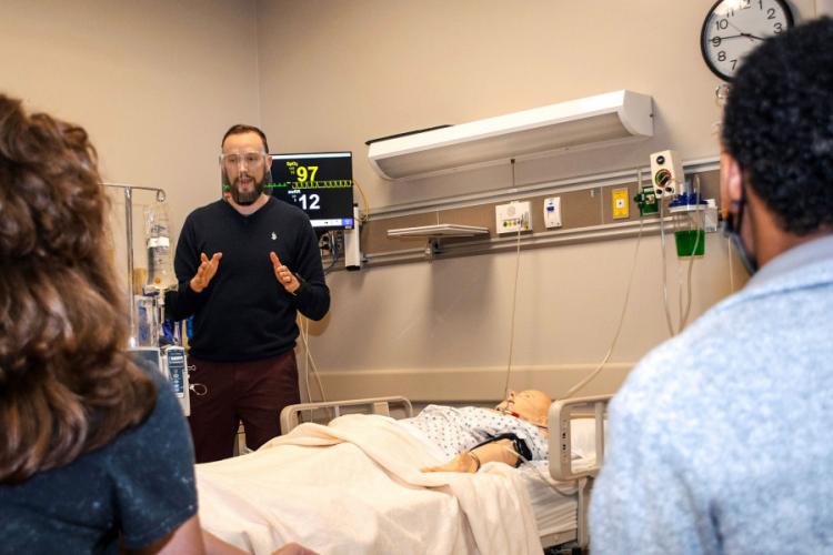Justin Pelham, clinical instructor in the School of Human Sciences instructing students in a simulated intensive care unit at SFA’s DeWitt School of Nursing.
