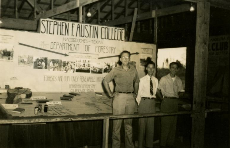 Photo dated 1949 with representatives of the new Department of Forestry standing in front of a student recruiting booth.
