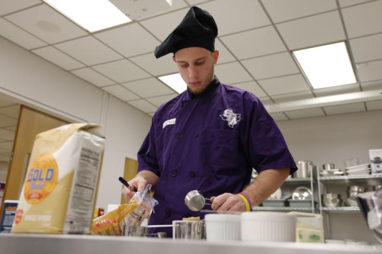 SFA senior Zackary Hughes prepares a meal