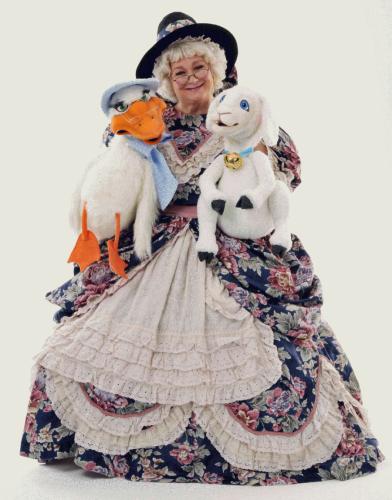 promotional image for “Reading and Rhyming with Mother Goose” featuring Mother Goose and two of her puppet firnds, Goosey and Lamby