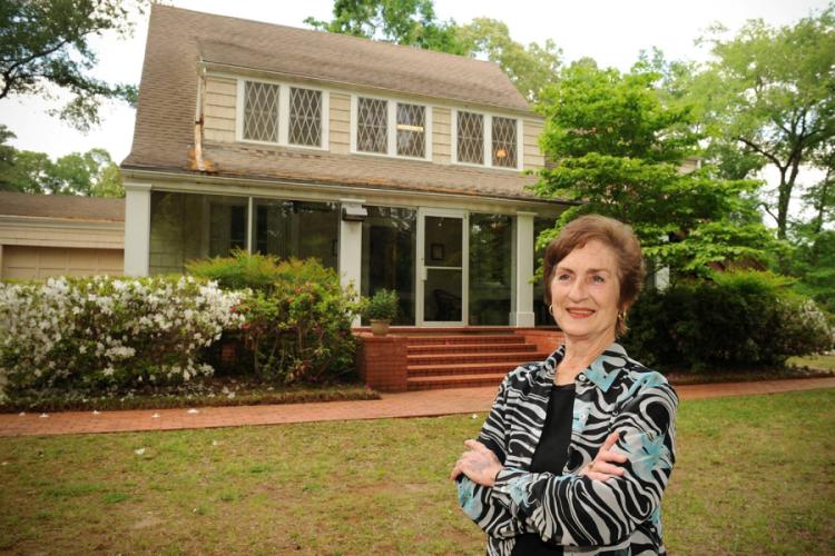 Pat Barnett standing near the Music Preparatory house