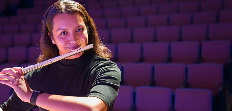 bachelor of music in performance student smiling with flute