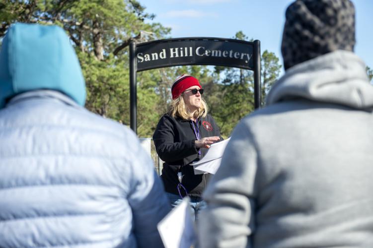 Dr. Perky Beisel provides an introduction at the entrance of the Sand Hill Cemetery Friday morning.