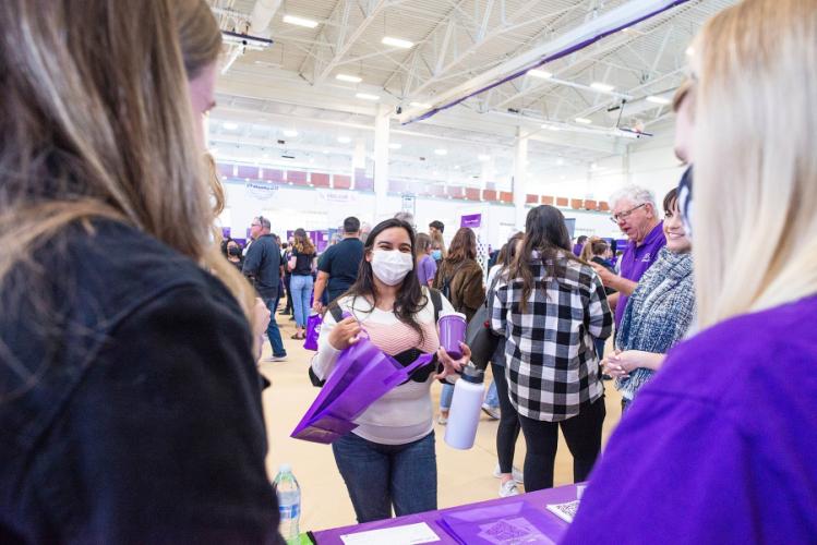 Attendees chat with faculty and staff during Stephen F. Austin State University’s Showcase Saturday academic fair. 