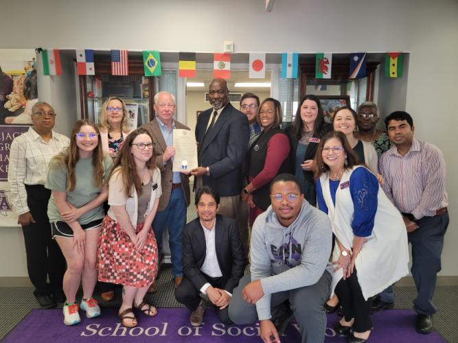 Nacogdoches County Commissioner Robin Dawley holding the proclamation with Dr. Freddie Avant, director of the School of Social Work while other SFA School of Social Work faculty, staff and students pose for the photo