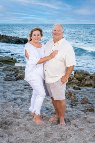 SFA alumni Michelle and Harmon Smith take a photo together on a beach.