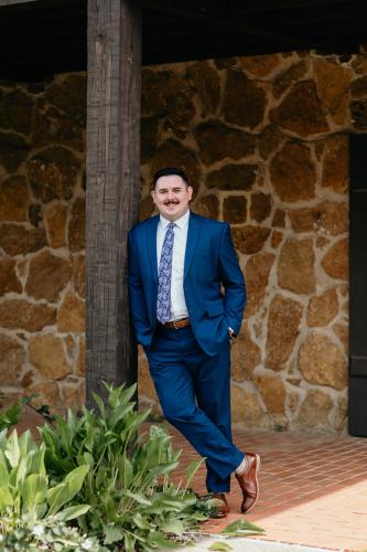Jordan Coleman, a Master of Arts in public history student from Effingham, Illinois, stands in front of the Old Stone Fort.