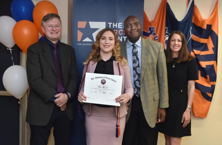 Tara Bocock holds her certificate of completion of the Archer Fellowship Program and is accompanied by Dr. Donal Skinner, Dr. Archie Holmes and Katie Romano.