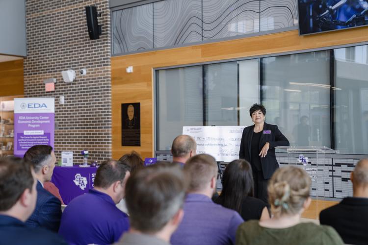 Mary Ann Rojas speaks in the SFA STEM Center lobby during a CARRI event.