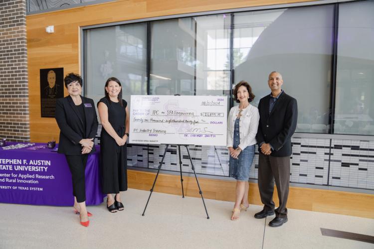 Mary Ann Rojas, Cory Blaylock, Dr. Kimberly Childs and Dr. Lorenzo Smith present a check to support faculty training sessions