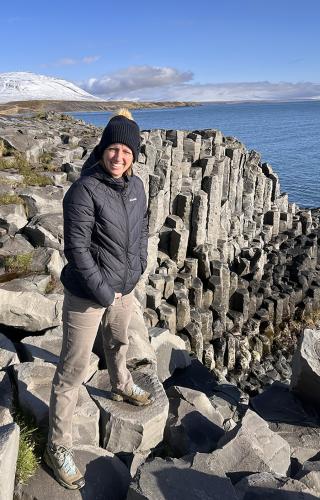 Lauren Selden stands at the Staðarbjörg Basalt Column in Iceland