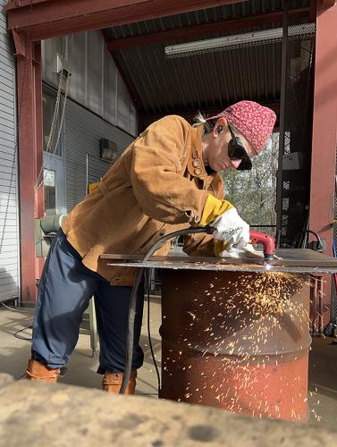 Lauren Seldenis shown plasma cutting steel at the Iron Studio during the Penland Winter Residency in North Carolina