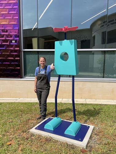 Lauren Selden installs Sally Brown, a fabricated steel sculpture acquired by the Micky Elliott College of Fine Arts for its permanent art collection