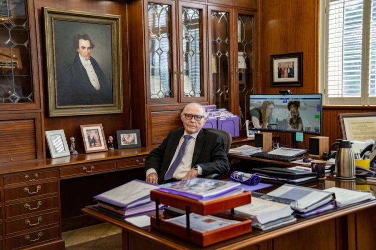 Dr. William R. Johnson, Stephen F. Austin State University’s fourth president, seated in the president’s office during a campus visit for SFA’s centennial celebrations held in 2023