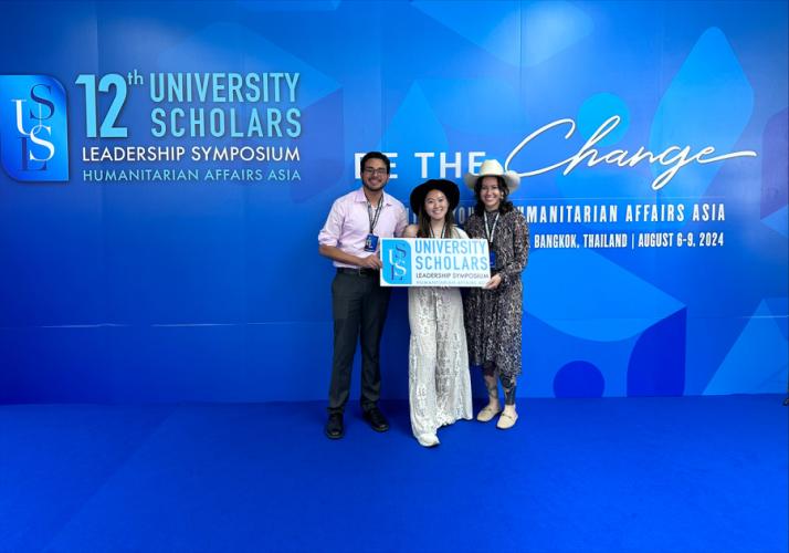 SFA students Oscar Sanchez, Mackenzie Damon and Brianna Patterson stand in front of a conference backdrop at the United Nations Conference Centre in Bangkok, Thailand.